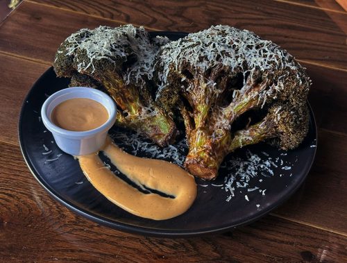 Burnt Ends Broccoli & Aioli burnt ends broccoli sprinkled with shredded cheese and a side of aioli at Cutler's Public house in Santa Barbara,CA